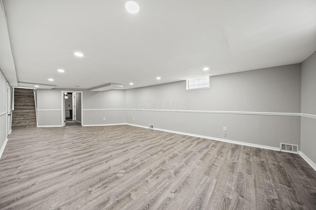2960 Berwick Blvd, Columbus, OH 43209 - unfurnished living room featuring wood finished floors, baseboards, recessed lighting, and stairway