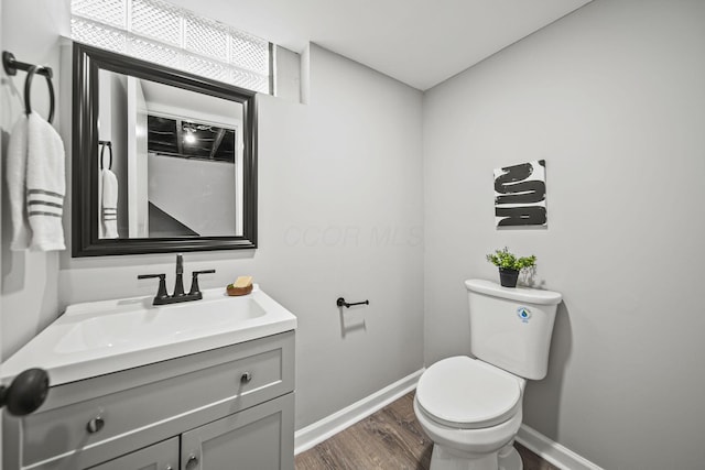 2960 Berwick Blvd, Columbus, OH 43209 - half bath featuring baseboards, wood finished floors, toilet, and vanity