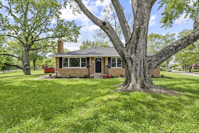 2960 Berwick Blvd, Columbus, OH 43209 - view of front of house with a chimney, brick siding, and a front lawn