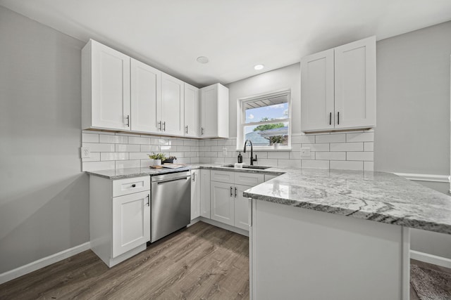 2960 Berwick Blvd, Columbus, OH 43209 - kitchen with a sink, dishwasher, a peninsula, wood finished floors, and light stone countertops