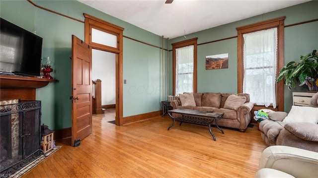 living area with a ceiling fan and light wood-style floors