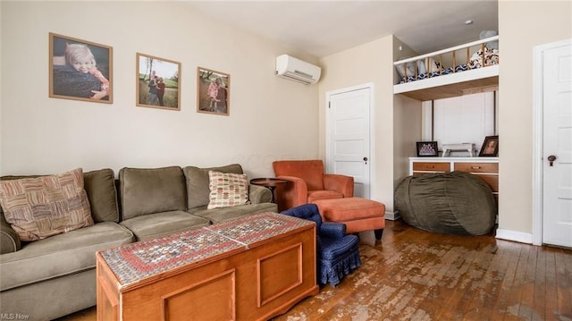 living room with a wall unit AC, wood-type flooring, and baseboards