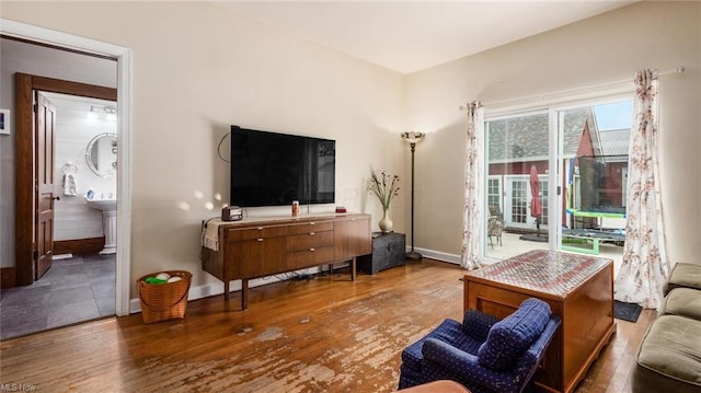 living area featuring baseboards and wood finished floors