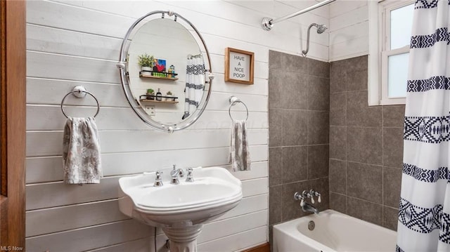 full bath with a sink and shower / tub combo with curtain