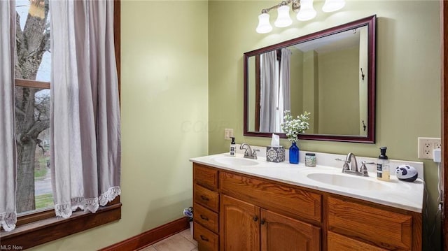 bathroom featuring tile patterned floors, double vanity, and a sink