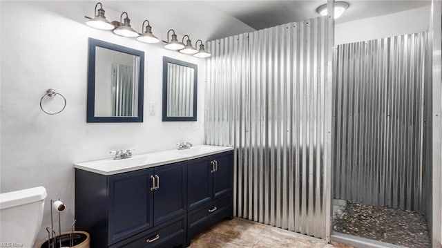 bathroom featuring a sink, toilet, and double vanity