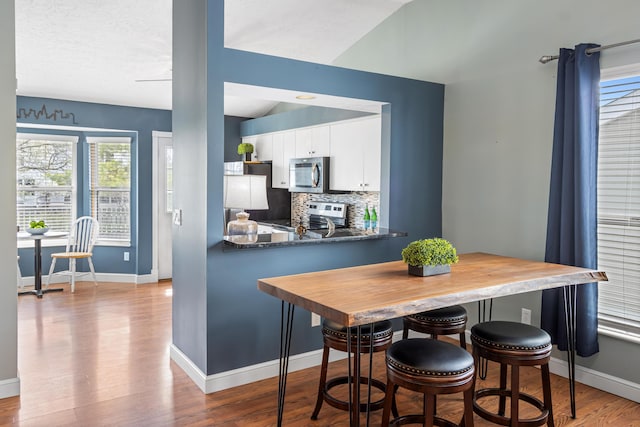 dining room featuring wood finished floors and baseboards