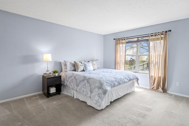carpeted bedroom with baseboards and visible vents