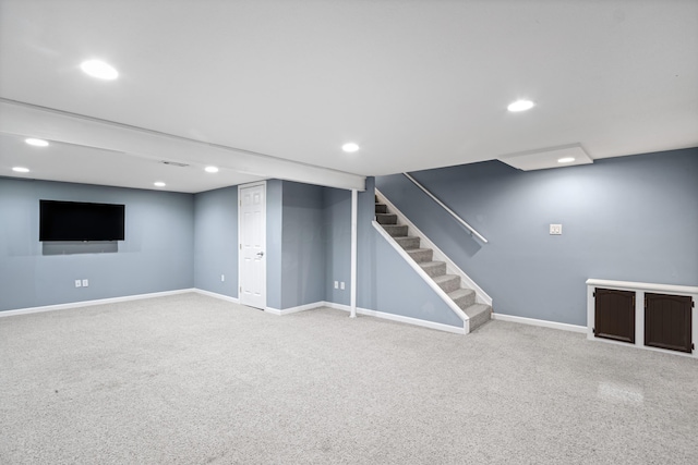 finished below grade area featuring stairway, baseboards, carpet flooring, and recessed lighting