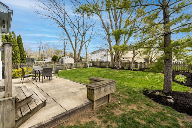 view of yard featuring a fenced backyard, a patio, and outdoor dining area