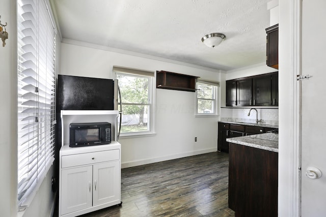 3113 Oaklawn St, Columbus, OH 43224 - kitchen featuring black microwave, plenty of natural light, dark wood-style flooring, light stone counters, and a textured ceiling