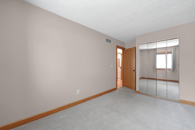 441 Gentlewind Dr, Westerville, OH 43081 - unfurnished bedroom with visible vents, a closet, baseboards, a textured ceiling, and carpet flooring