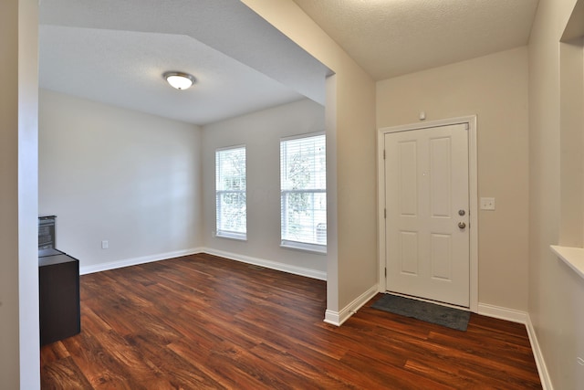 6134 Glade Run Rd, Hilliard, OH 43026 - entryway with dark wood-style flooring, baseboards, and a textured ceiling