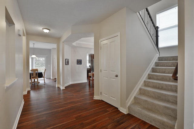 6134 Glade Run Rd, Hilliard, OH 43026 - hallway featuring dark wood-style flooring, stairway, and baseboards