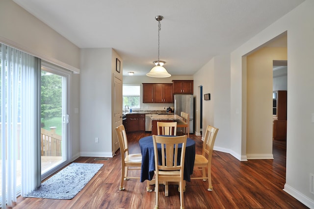 6134 Glade Run Rd, Hilliard, OH 43026 - dining space featuring baseboards and dark wood-style flooring