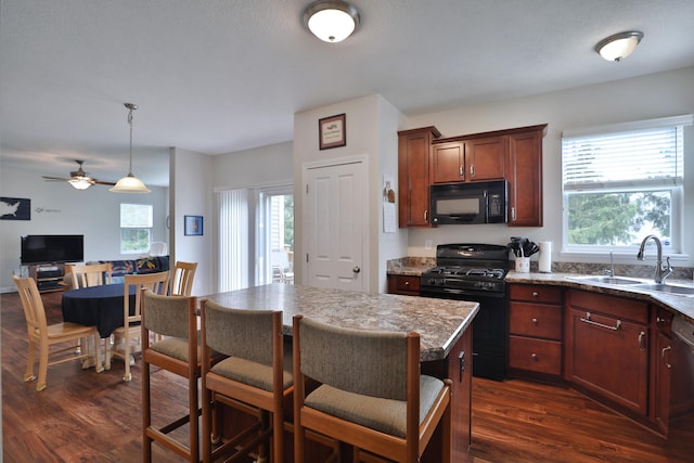 6134 Glade Run Rd, Hilliard, OH 43026 - kitchen with black appliances, a sink, dark wood finished floors, and plenty of natural light