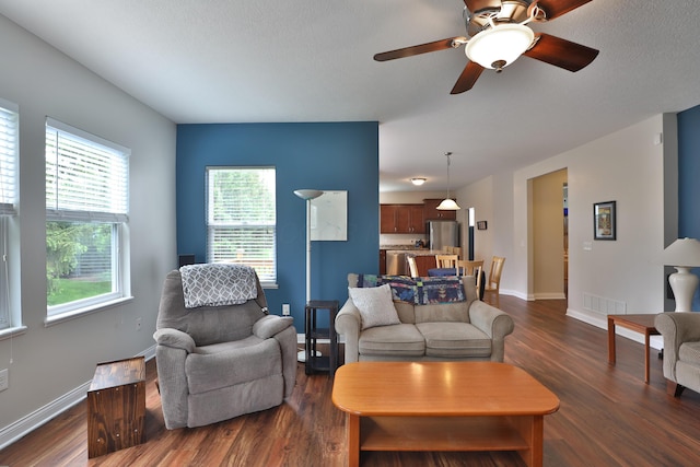 6134 Glade Run Rd, Hilliard, OH 43026 - living area featuring dark wood-type flooring, baseboards, and a ceiling fan