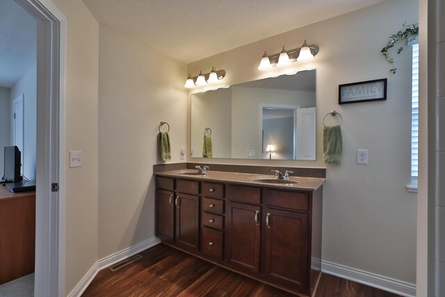 6134 Glade Run Rd, Hilliard, OH 43026 - bathroom featuring wood finished floors, double vanity, and baseboards