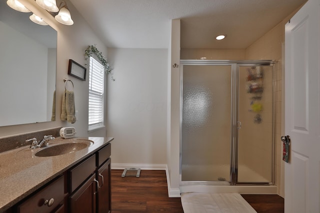 6134 Glade Run Rd, Hilliard, OH 43026 - bathroom featuring a stall shower, wood finished floors, vanity, baseboards, and recessed lighting