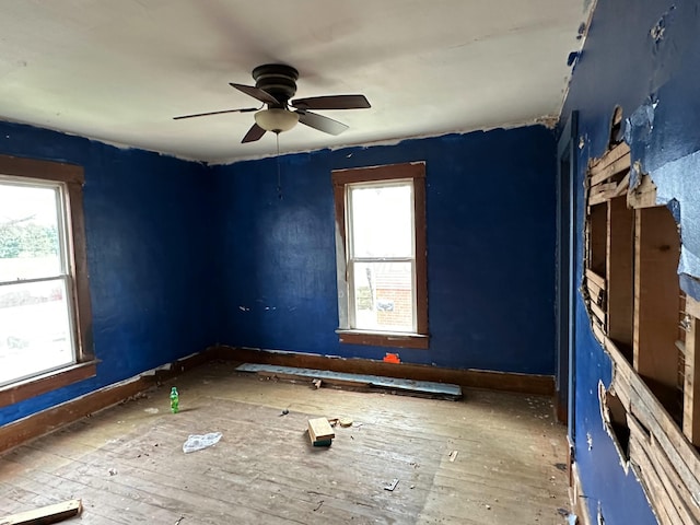 818 S Kibler St, New Washington, OH 44854 - empty room with plenty of natural light, wood-type flooring, and ceiling fan