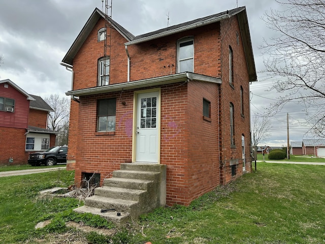 818 S Kibler St, New Washington, OH 44854 - rear view of property with entry steps, a yard, and brick siding