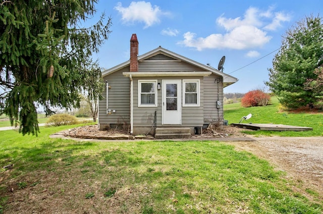 5235 Raiders Rd, Frazeysburg, OH 43822 - rear view of house with a chimney and a lawn