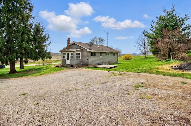 5235 Raiders Rd, Frazeysburg, OH 43822 - rear view of property with a chimney, driveway, and a lawn