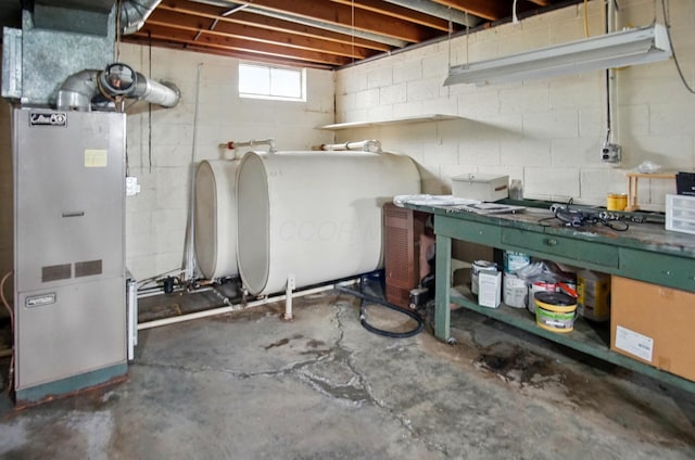 5235 Raiders Rd, Frazeysburg, OH 43822 - below grade area with heating unit, a workshop area, heating fuel, and concrete block wall