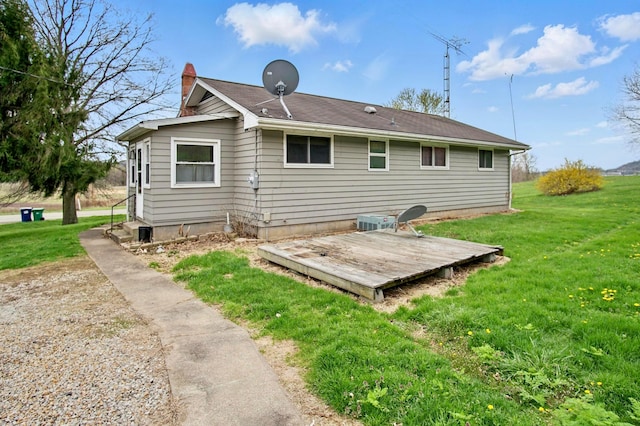 5235 Raiders Rd, Frazeysburg, OH 43822 - back of house with a chimney, a deck, and a lawn