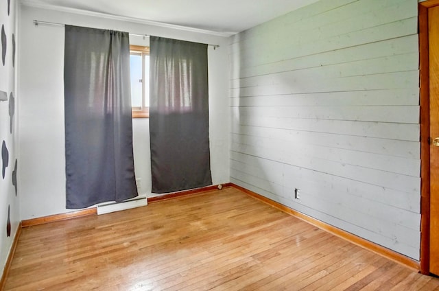 5235 Raiders Rd, Frazeysburg, OH 43822 - empty room featuring wooden walls, baseboards, and hardwood / wood-style floors