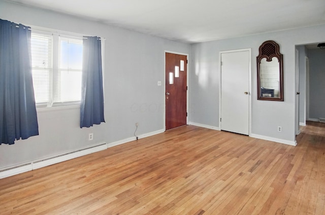 5235 Raiders Rd, Frazeysburg, OH 43822 - entrance foyer with a baseboard radiator, light wood finished floors, and baseboards