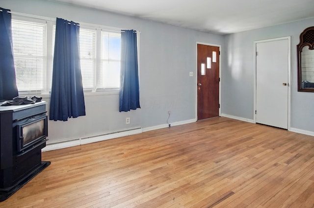 5235 Raiders Rd, Frazeysburg, OH 43822 - entrance foyer with light wood-style floors, a baseboard heating unit, plenty of natural light, and a wood stove