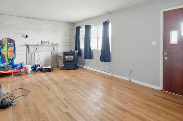 5235 Raiders Rd, Frazeysburg, OH 43822 - interior space featuring a baseboard heating unit, a wood stove, baseboards, and hardwood / wood-style flooring