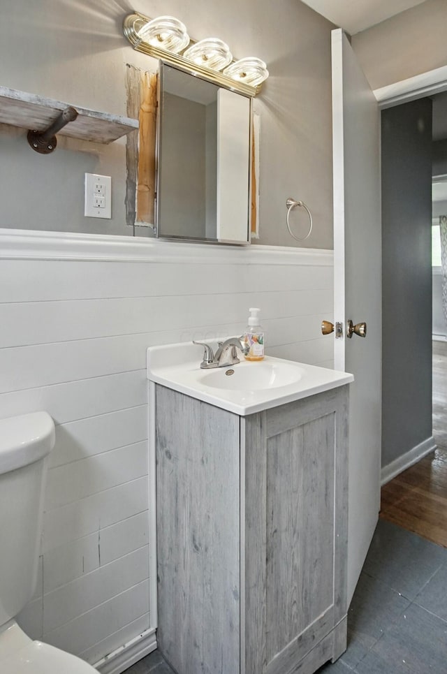 5235 Raiders Rd, Frazeysburg, OH 43822 - bathroom with tile patterned flooring, toilet, vanity, and wainscoting