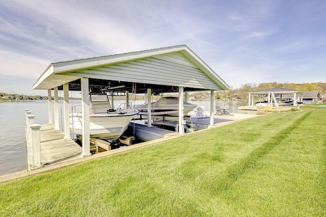dock area featuring a lawn, a water view, and boat lift