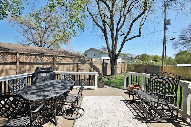 5580 Millington Rd, Columbus, OH 43235 - view of patio with outdoor dining area, a wooden deck, and a fenced backyard