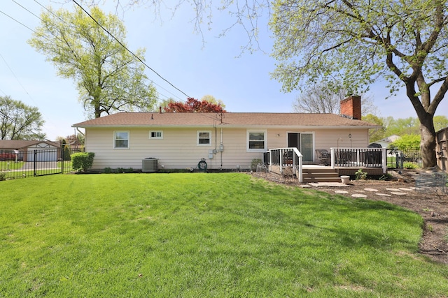 5580 Millington Rd, Columbus, OH 43235 - back of property featuring a chimney, a deck, a lawn, central air condition unit, and fence