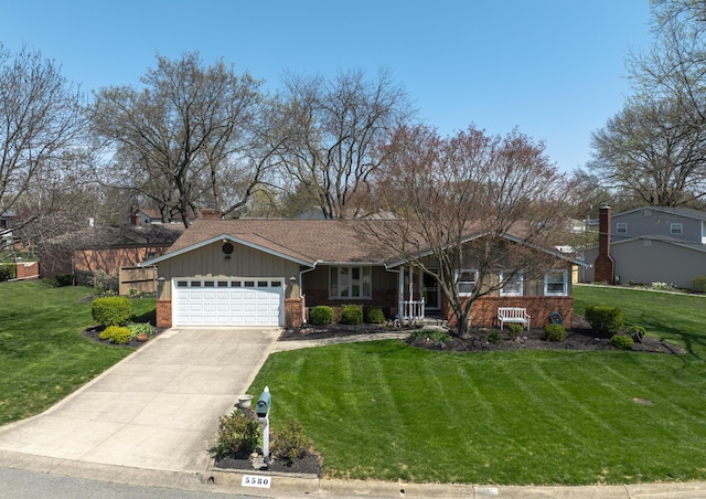 5580 Millington Rd, Columbus, OH 43235 - view of front of property featuring a front yard, a garage, and brick siding