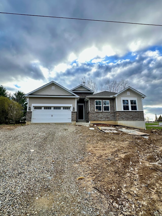 211 Candlewood Dr Unit 9, Mount Gilead, OH 43338 - view of front of property featuring a garage and gravel driveway