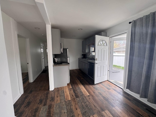 4620 Boynton Pl, Columbus, OH 43227 - kitchen with dark countertops, dishwasher, dark wood-style floors, and a sink