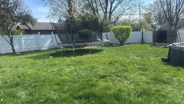 4620 Boynton Pl, Columbus, OH 43227 - view of yard featuring a trampoline and a fenced backyard