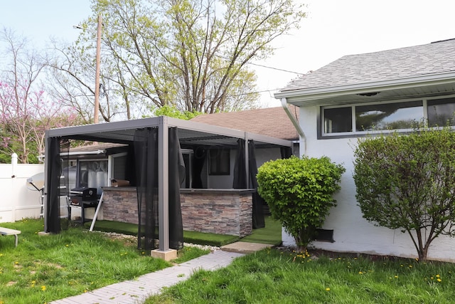4620 Boynton Pl, Columbus, OH 43227 - view of side of home with a yard, a shingled roof, stucco siding, and fence