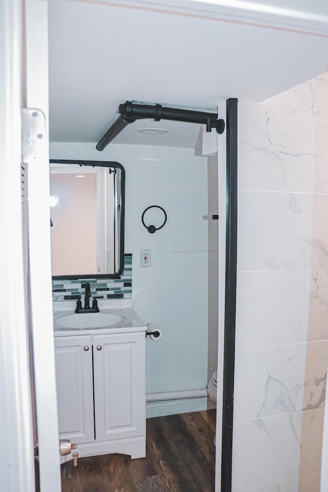 4620 Boynton Pl, Columbus, OH 43227 - bathroom featuring decorative backsplash, wood finished floors, vanity, and toilet