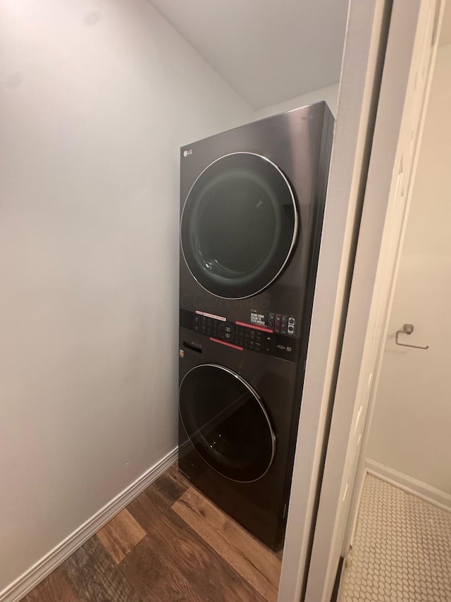 4620 Boynton Pl, Columbus, OH 43227 - laundry area featuring stacked washer and dryer, wood finished floors, baseboards, and laundry area