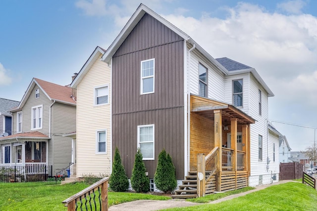 exterior space with fence, a lawn, and covered porch