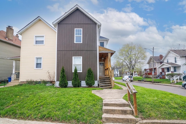 view of front of home with a front yard and a residential view