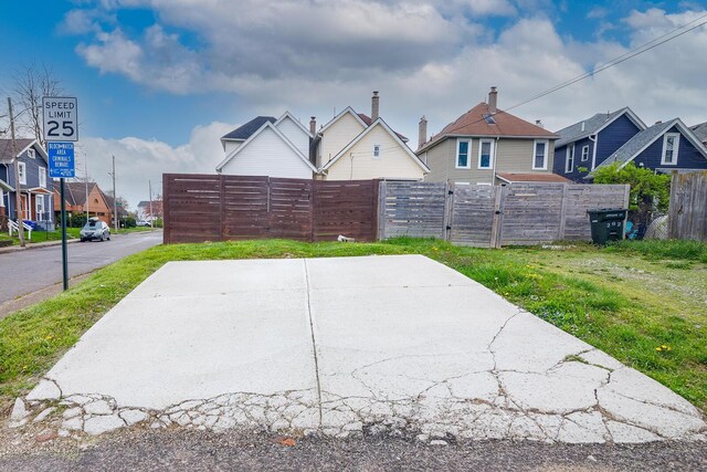 view of patio / terrace with fence and a residential view