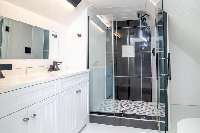 full bathroom featuring a sink, double vanity, toilet, a stall shower, and lofted ceiling