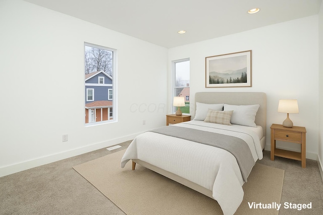 bedroom with light colored carpet, baseboards, visible vents, and recessed lighting