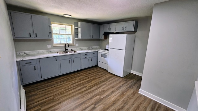kitchen featuring white appliances, a textured ceiling, open shelves, dark wood-type flooring, and a sink